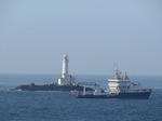 SX03065 Ship sailing past lighthouse on rocky outcrop near Rosslare (Tuskar Rock).jpg